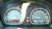 <b>Your Hatch Is Open - </b>After a mile or two in the X3 I noticed that bug looking thing in the center of the gages. Looks like a door is open warning light, so I pulled into a bank parking lot and checked all the doors, they were closed. The rear hatch segment is brighter than the rest, so I checked it too. It looked a little open, but I could move it one way or the other, so I finished the loop without mishap. (03/35/08) Your Hatch Is Open
