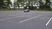 <b>Independence - </b>The Emperor likes to assert his independence by parking far out in the lot away from all the other automobiles. And he succeeds as well as any car, surrounded by an 8-foot high chain link fence with strands of barbed wire on top, can. (06/29/2005) Independence