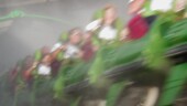 <b>Motion - </b>The Hulk roller coaster at Islands of Adventure in Orlando, Florida emerges from a "smoke" filled tunnel. After launching you like a jet off an aircraft carrier (using magnetics instead of steam) up a hundred feet in the air or so, rolling you 360 degrees, it then plunges down into the lake via a tunnel, where you emerge heading back up for more thrills. This is all in the first 15 seconds of the ride. :-) (01/16/2004) OLYMPUS DIGITAL CAMERA