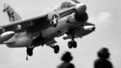 <b>Black and White - </b>An A-7E on its way to touching down aboard the U.S.S. Midway. I took this picture standing in the catwalk that surrounds the flight deck. The 2 fellows in front of me have a "fun" job, once a plane has caught the wire, they rush out behind the plane, waiting for it to raise its tail hook. They then guide the dropped arresting cable as it is reeled back in, making sure it doesn't snag on one of the other cables. And then jump quickly back to the side as another 20-ton jet pounds onto the deck about a minute behind this one. Black and White