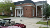 <b>Marion - 29571-3641 - </b>It was nearly impossible to get a shot of the car and the front of this PO. Even if I parked in the middle of the busy main street the trees that were growing in front obscured the building enough that you can't tell it is a Post Office. (04/19/08)" Marion - 29571-3641