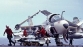 <b>Heavy Metal - </b>The red shirted ordinance men were the folks that loaded the "heavy metal" onto the planes on the flight deck of the carrier. Here, a few of them load AIM-9 Sparrow missiles on an A-6 Intruder. Most of the time the planes just carried the air to air missiles for self defensive purposes, but when they were flying bombing exercises these guys would get a workout loading the 250 and 500 pound bombs. Heavy-Metal