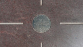 <b>The Spot - </b>The survey marker planted in the middle of the big granite square where four state borders touch. Or Do they? A couple days before we visited there was a news story that broke saying that the correct spot may be up to 2-1/2 miles away. (04/22/09) The Spot