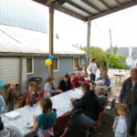 <b>Baby Shower 1 - </b>Saturday's mid-day was filled with the sound of grilling hamburgers and the tearing of wrapping paper. There were probably 35-40 guests outside the barn. This is looking to the right down the table. (09/30/06) Baby Shower 1