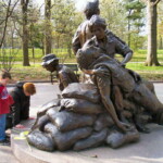 <b>Women's Vietnam War Memorial - </b>This woman waited patiently on a nearby bench as Donna, Sally and I walked all around the Womans Vietnam War Memorial. As we we leaving she got up and kneeled in front of it. Pehaps her mother served... (04/10/2007) Women's Vietnam War Memorial