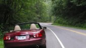<b>June - </b>Like a dog on a leash, the Miata sits by the side of the road seemingly ready to jump and chase the curves ahead. June