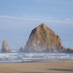 <b>Haystack Rock Morning - </b>Finally the sun breaks through the clouds and has risen enough to fully light the scene. (10/02/06) Haystack Rock Morning