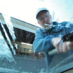 <b>Scraping Ice - </b>The ice crystals were a lot more prevalent and closer together on the windshield. Lucky for me the folks at Alamo left an ice scraper on the back shelf. Donna snapped this image as she sat inside the rapidly warming interior of the car. (04/12/2007) Scraping Ice