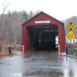 <b>West Cornwall - </b>This historic, red-painted bridge was designed by Ithiel Town and built in 1841. It's been in continuous service since 1864--you can still drive across the bridge, which spans the Housatonic River for a distance of 242-feet. It is said to be the state's most photogenic specimen, but you wouldn't know it on this cold rainy day. (04/12/2007) West Cornwall