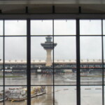 <b>Rainy Dulles - </b>The torrential rains we drove through from NJ to get here had quit leaving behind a pretty steady rain. A failed attempt to get a picture of the historical terminal and tower and their little shuttle buses. (04/15/2007) Rainy Dulles