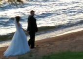 <b>The Newlyweds</b> - Jennifer and Albert walk along the shore as the wedding photographer tries to capture just the right image. (05/19/2018)