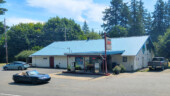 <em>Logsden</em> - Post Office number two today where it is inside the country store. The pickup is the proprietor's and the Prius belongs to a little old lady. I sat at the picnic table and had a Snickers ice cream bar. (8/23/25)