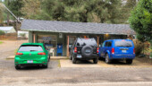 <em>Swisshome</em> - Behind the 2 SUVs are doors that made me think that there were a couple of very small living quarters. (3/8/26)